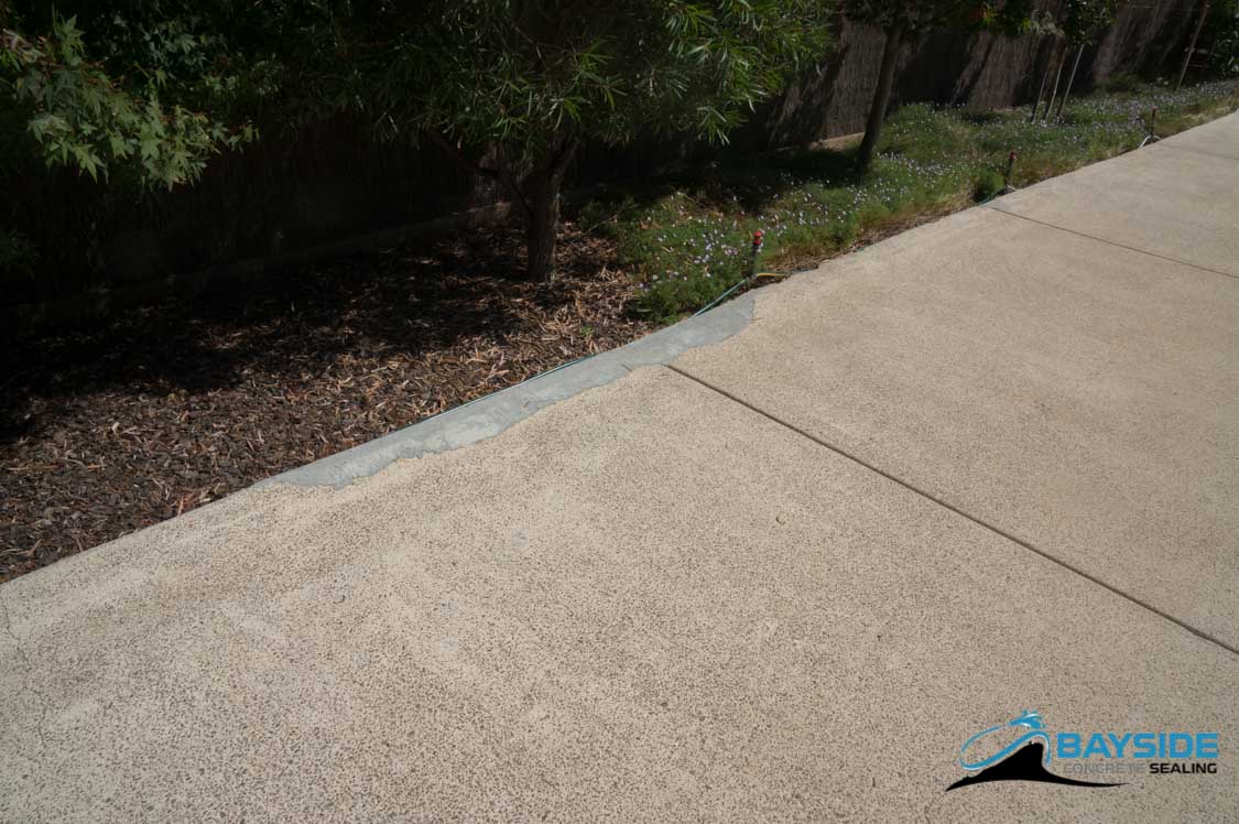 Exposed aggregate surface before and after restoration comparison area