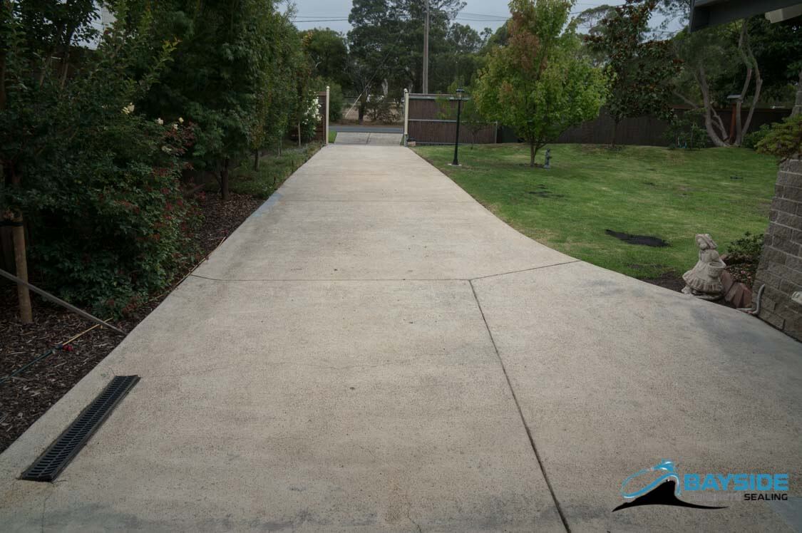 Restored weathered exposed aggregate driveway after professional sealing in Melbourne
